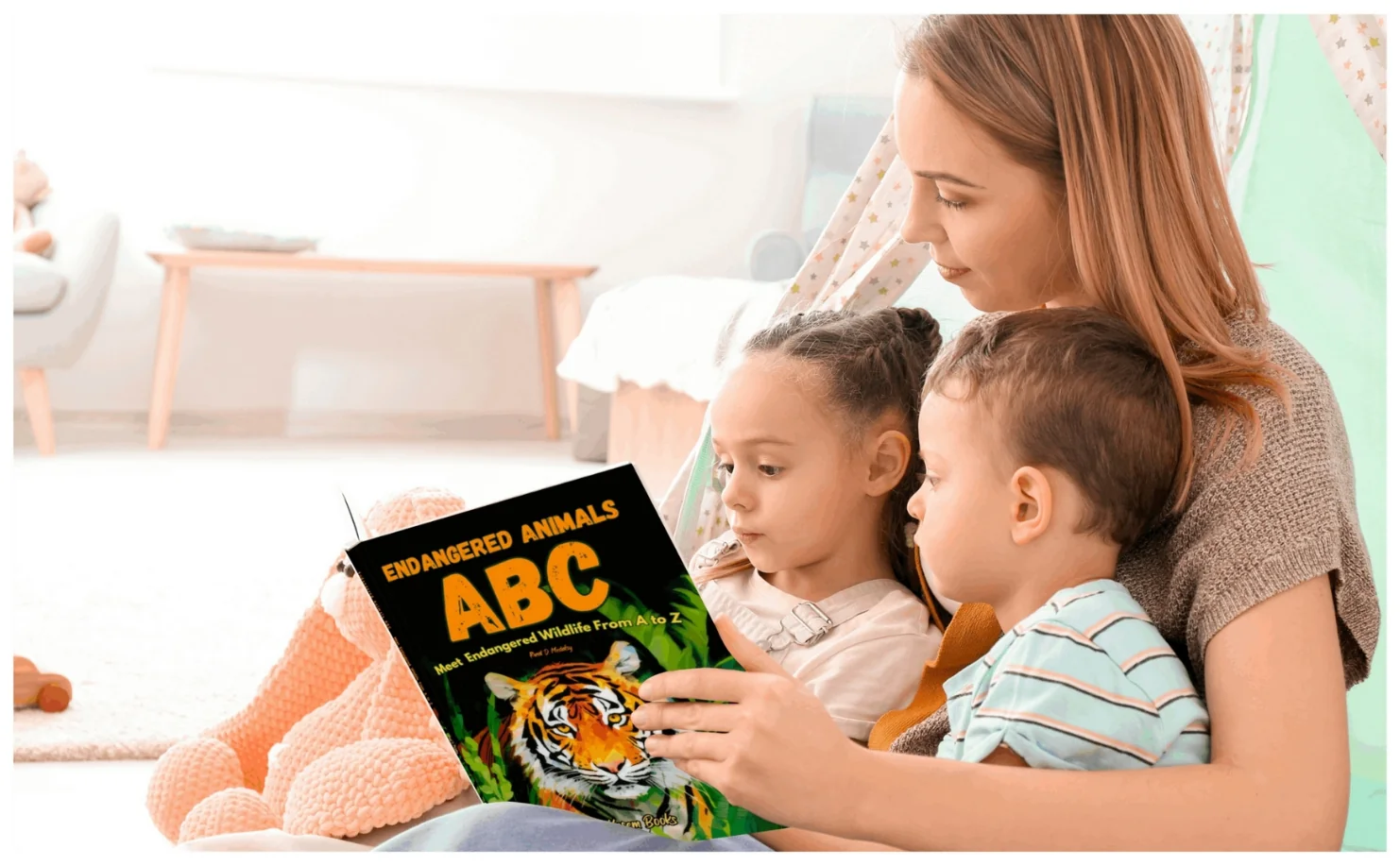 A mother reading Endangered Animals ABC with two children